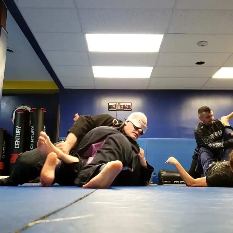 Students practicing grappling techniques during a martial arts class