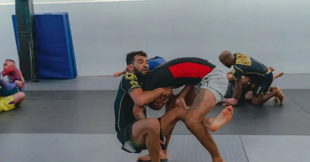 A Brazilian Jiu Jitsu practitioner attempting a takedown during a training session, highlighting beginner BJJ techniques.